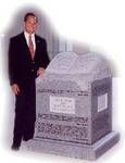 Judge Roy Moore standing next to 10 Commandments.